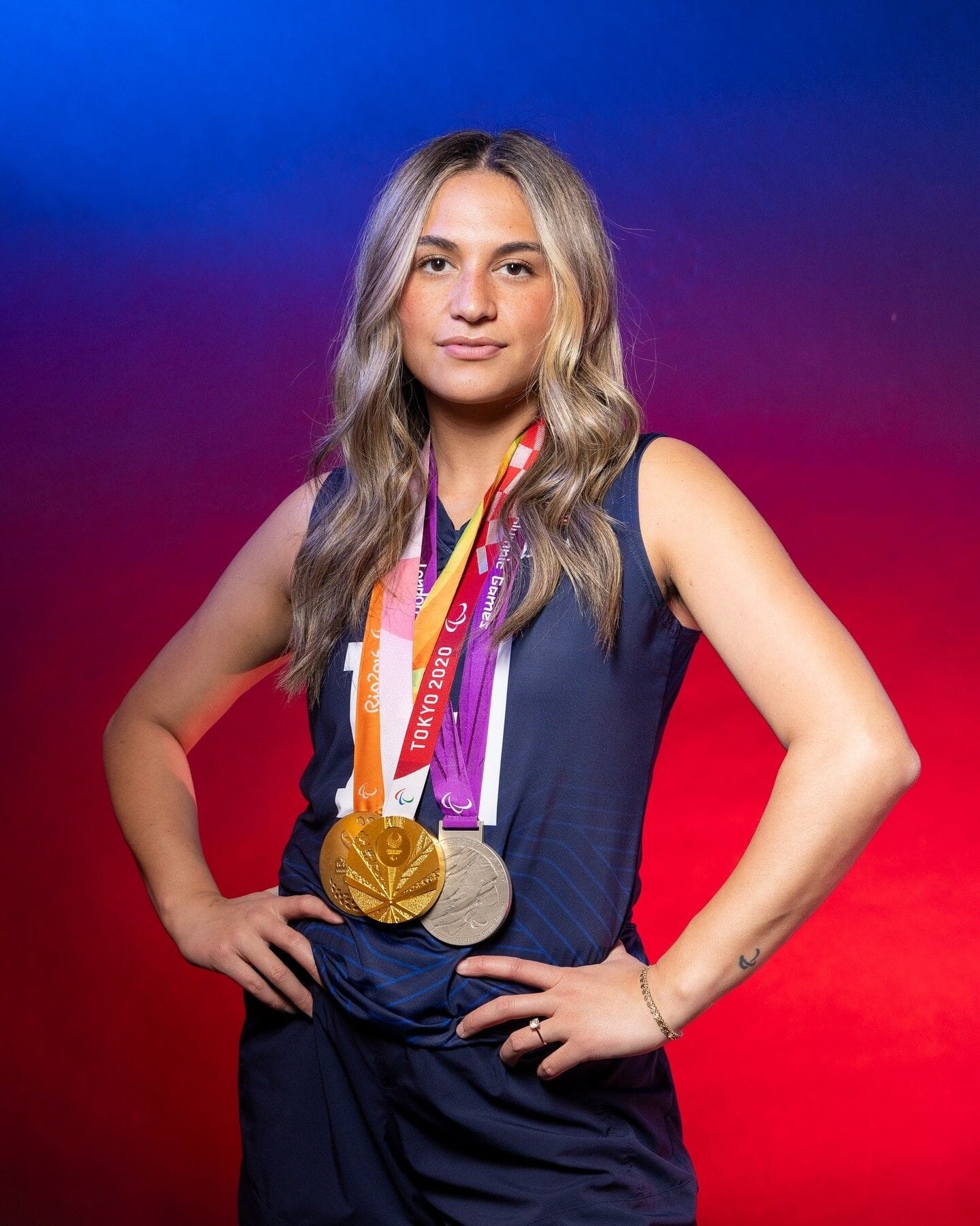 Kaleo posing with 3 Paralympic medals, 2 gold and 1 silver