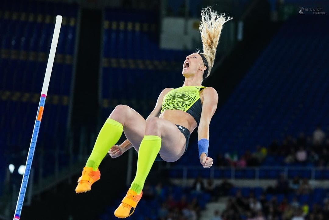 Sandi Morris mid air after a pole vault