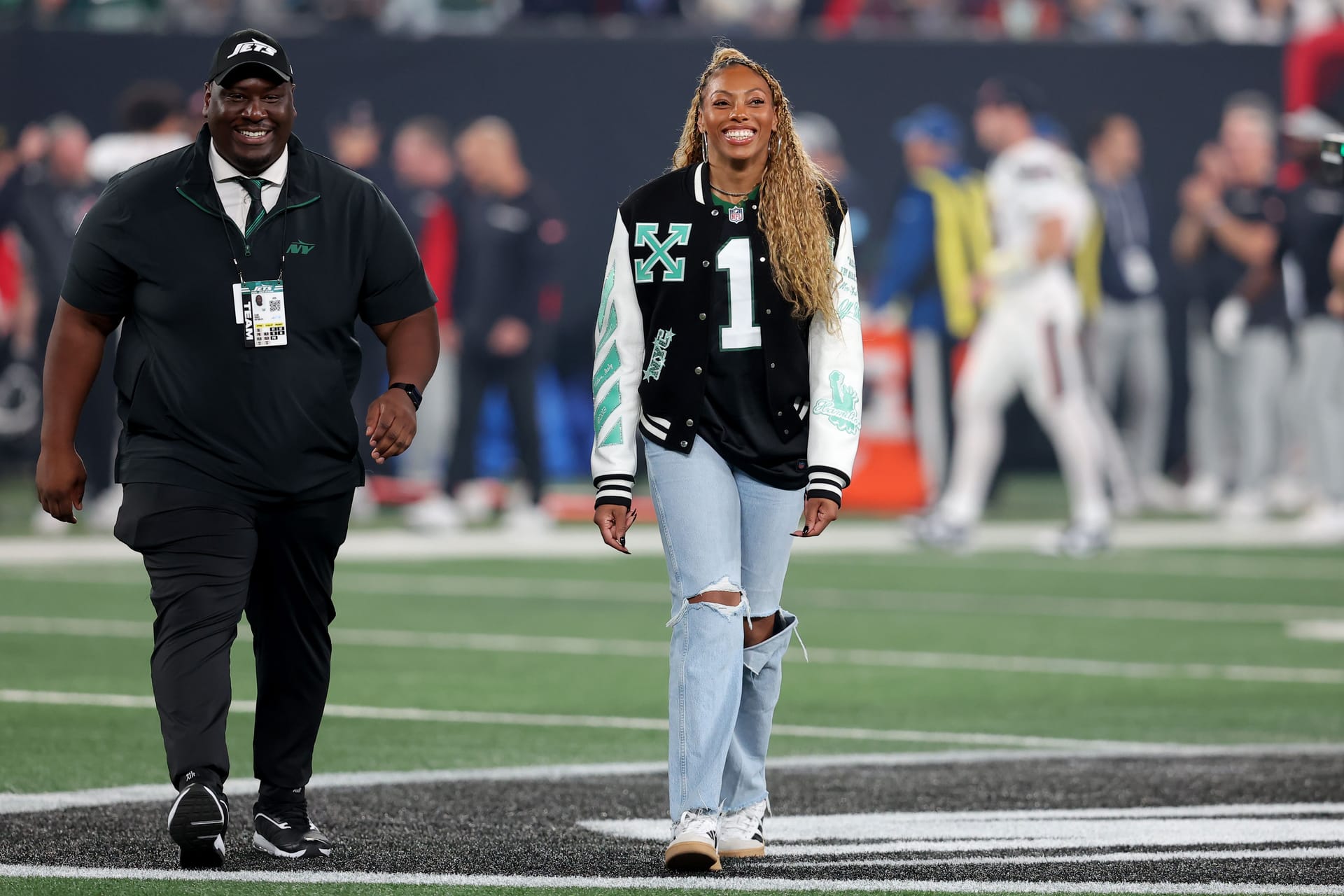 Oct 31, 2024; East Rutherford, New Jersey, USA; New York Liberty player and honorary Jets team captain Betnijah Laney-Hamilton walks off the field after the coin toss before a game between the New York Jets and the Houston Texans at MetLife Stadium. Source: Brad Penner-Imagn Images