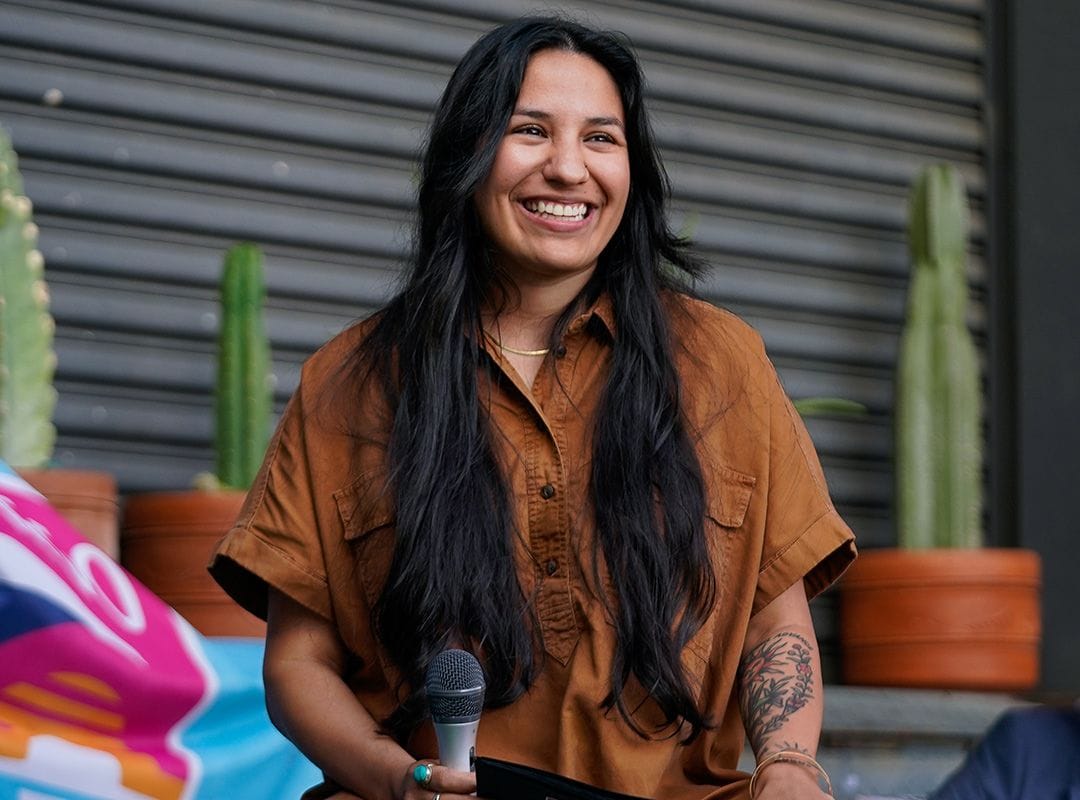 Gutierrez smiling with microphone in hand