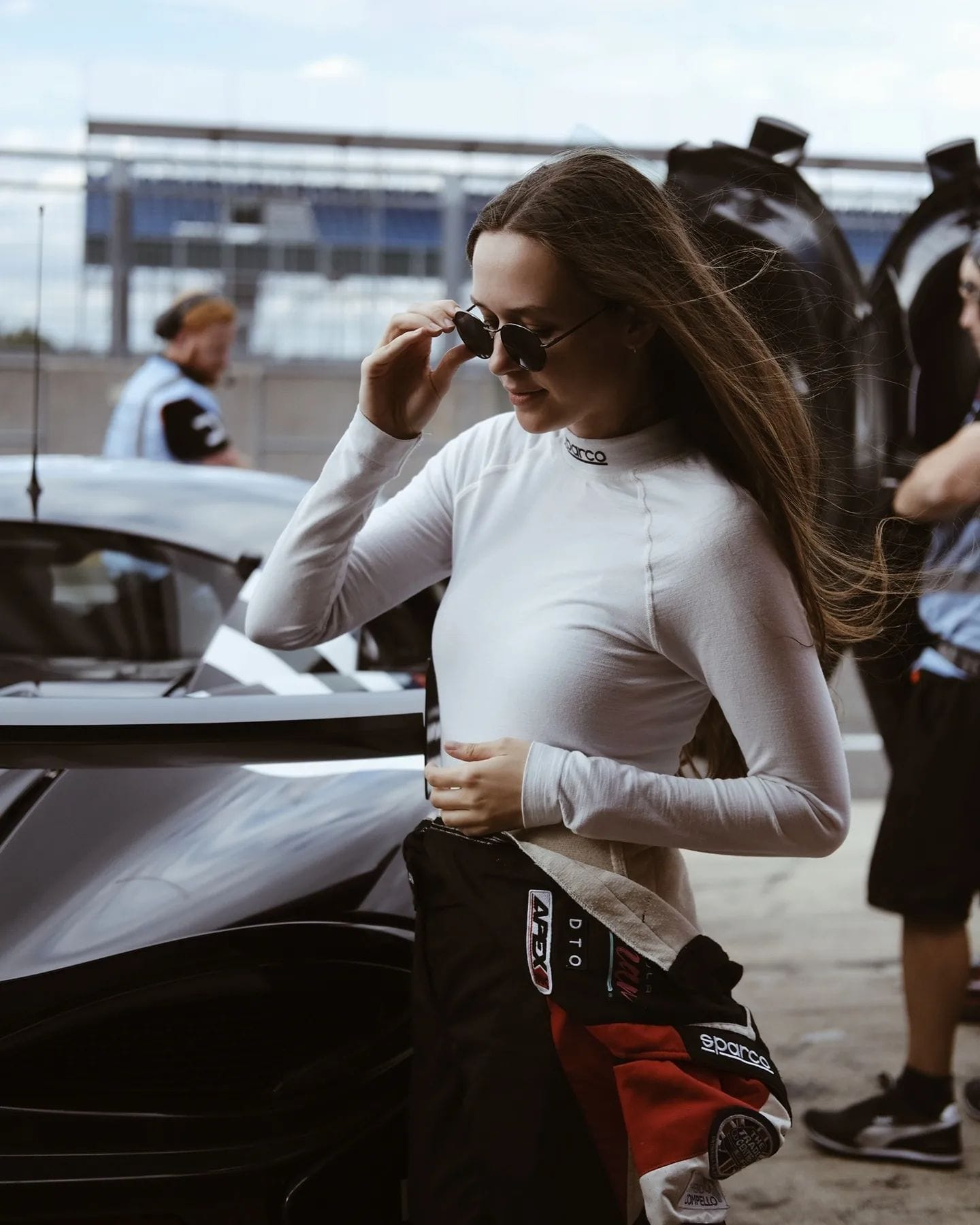 Erika Hoffmann in sunglasses and racing suit