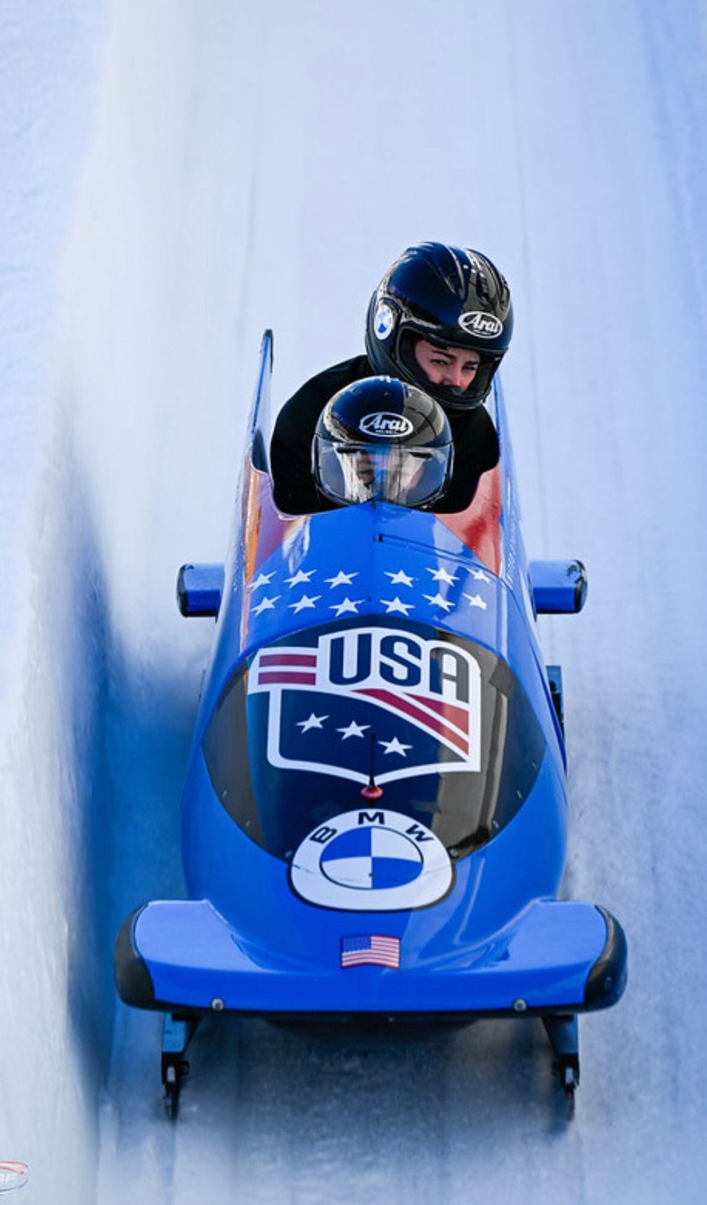Riley and a teammate racing in a double bobsled