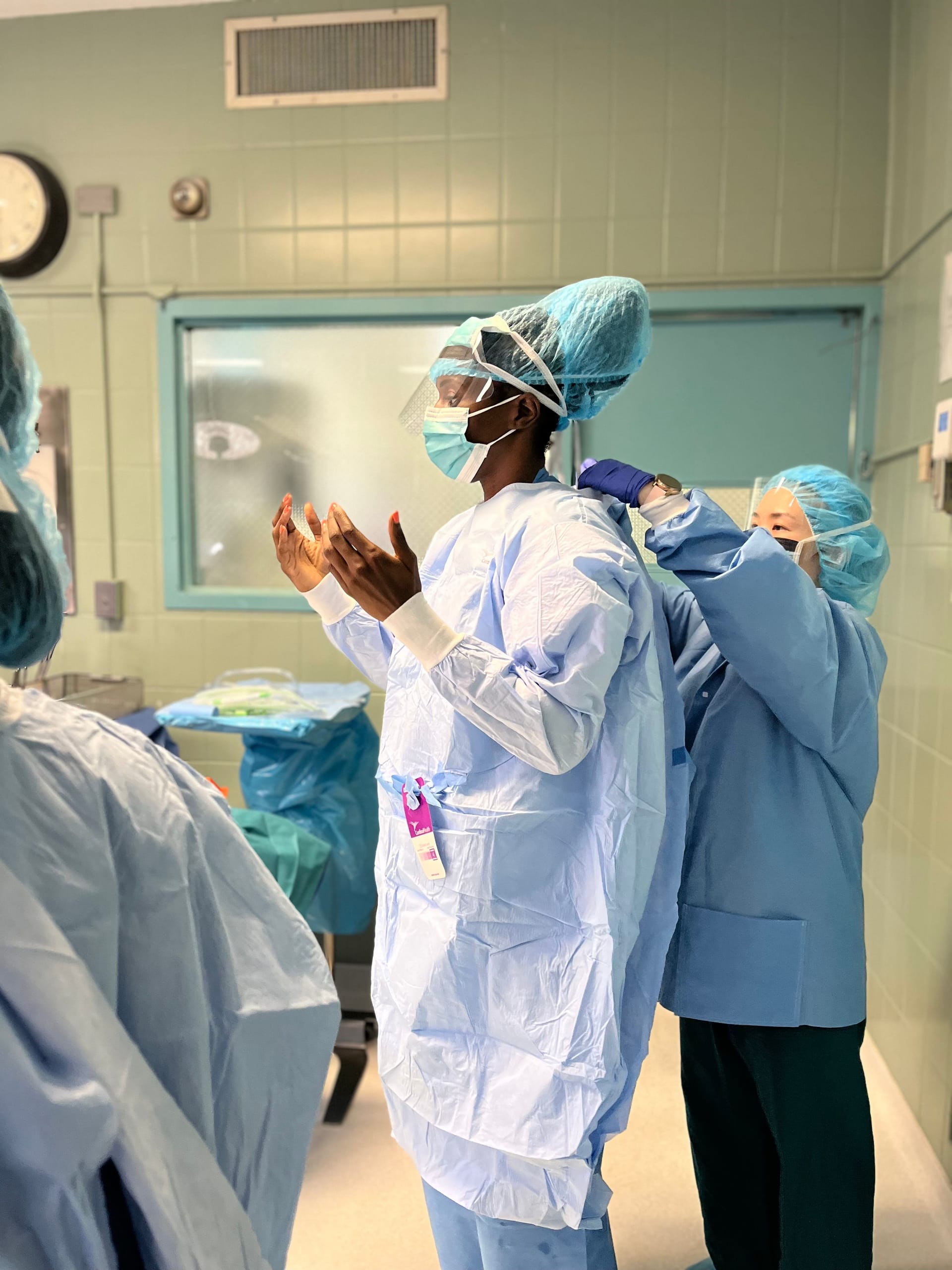 Ogoke getting scrubbed up in the operating room