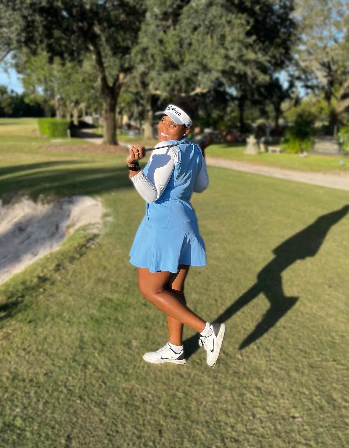 Monifa Sealy smiling on a golf course