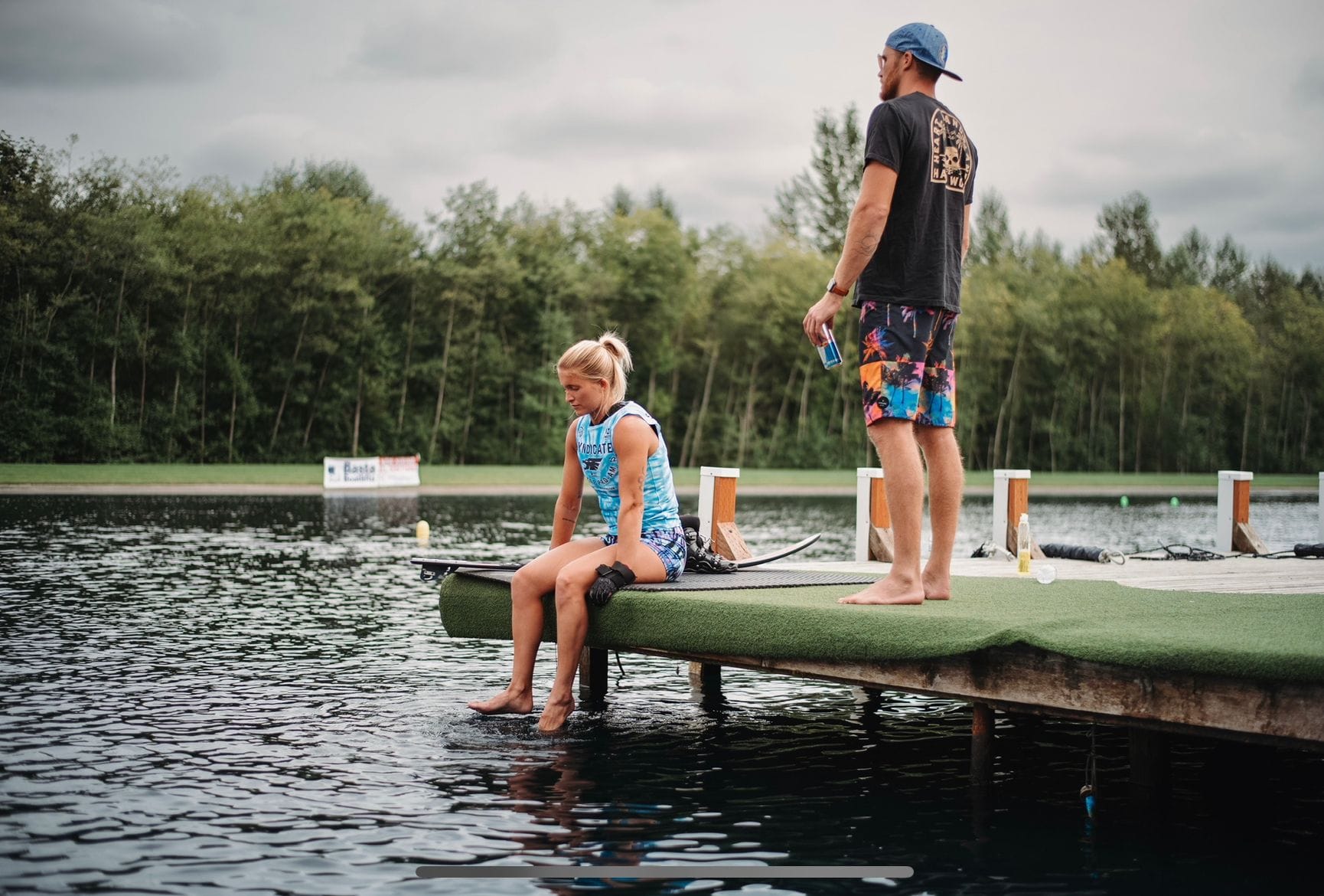 Elizabeth sits on a dock over the water