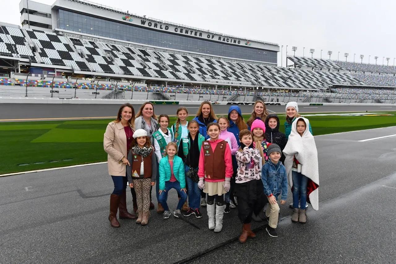 Aurora poses with a Girl Scout troop at the World Center of Racing track
