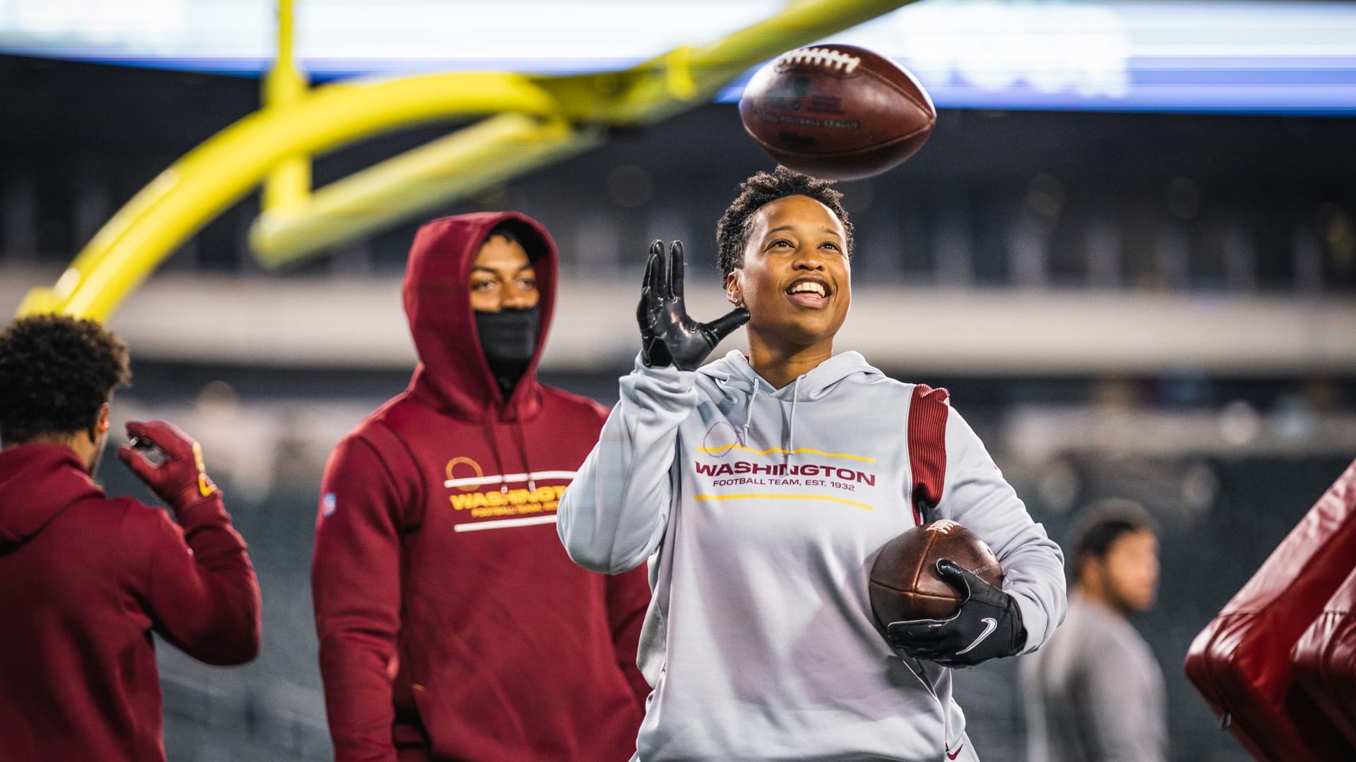 Jennifer tosses a football in the Washington Football Team stadium