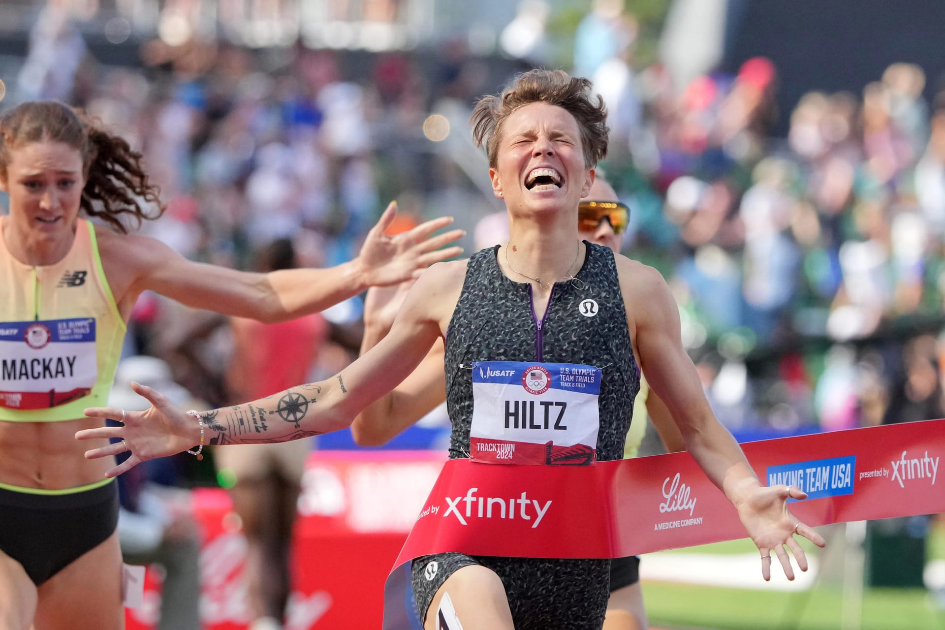 Nikki Hiltz runs through the ribbon at a race