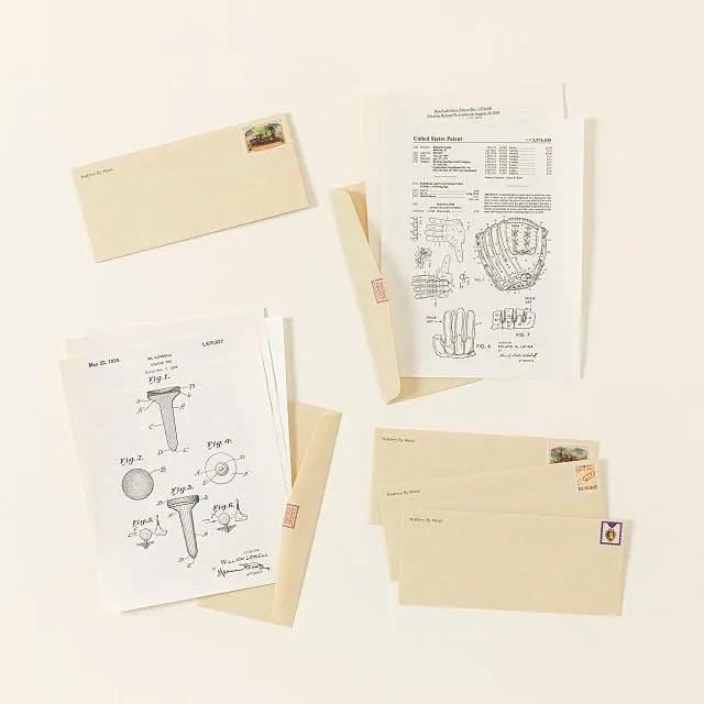 photo of technical drawings and envelopes on a white background