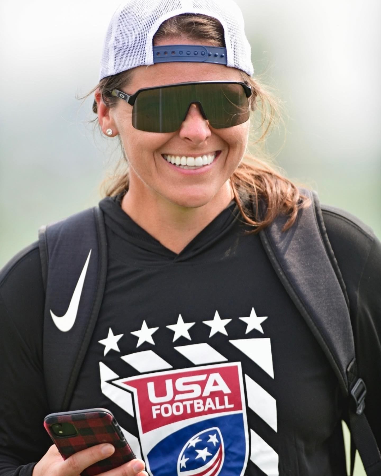 Liz smiling in a USA Football shirt