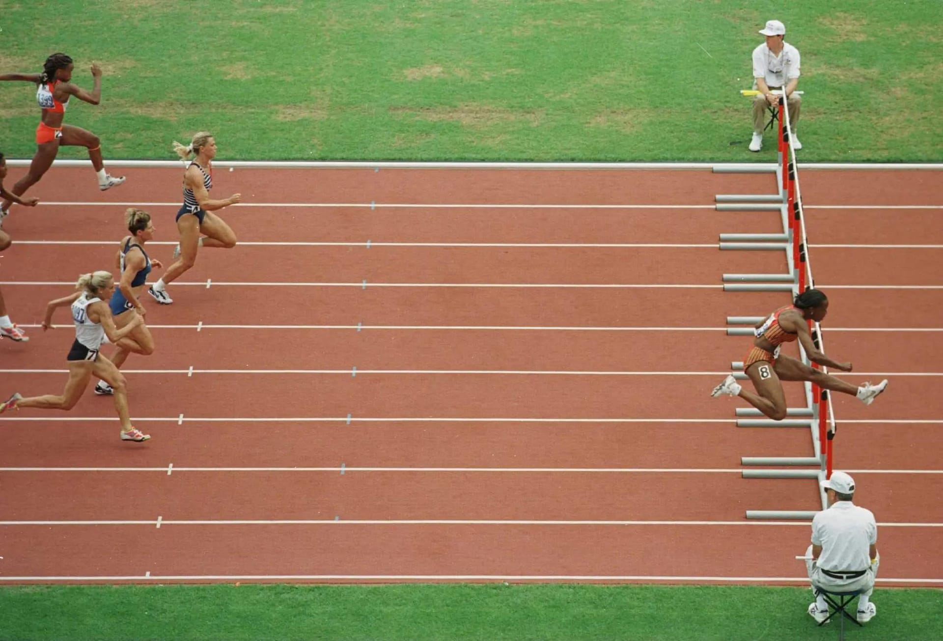 Jackie Joyner-Kersee jumping over hurdles in a competition