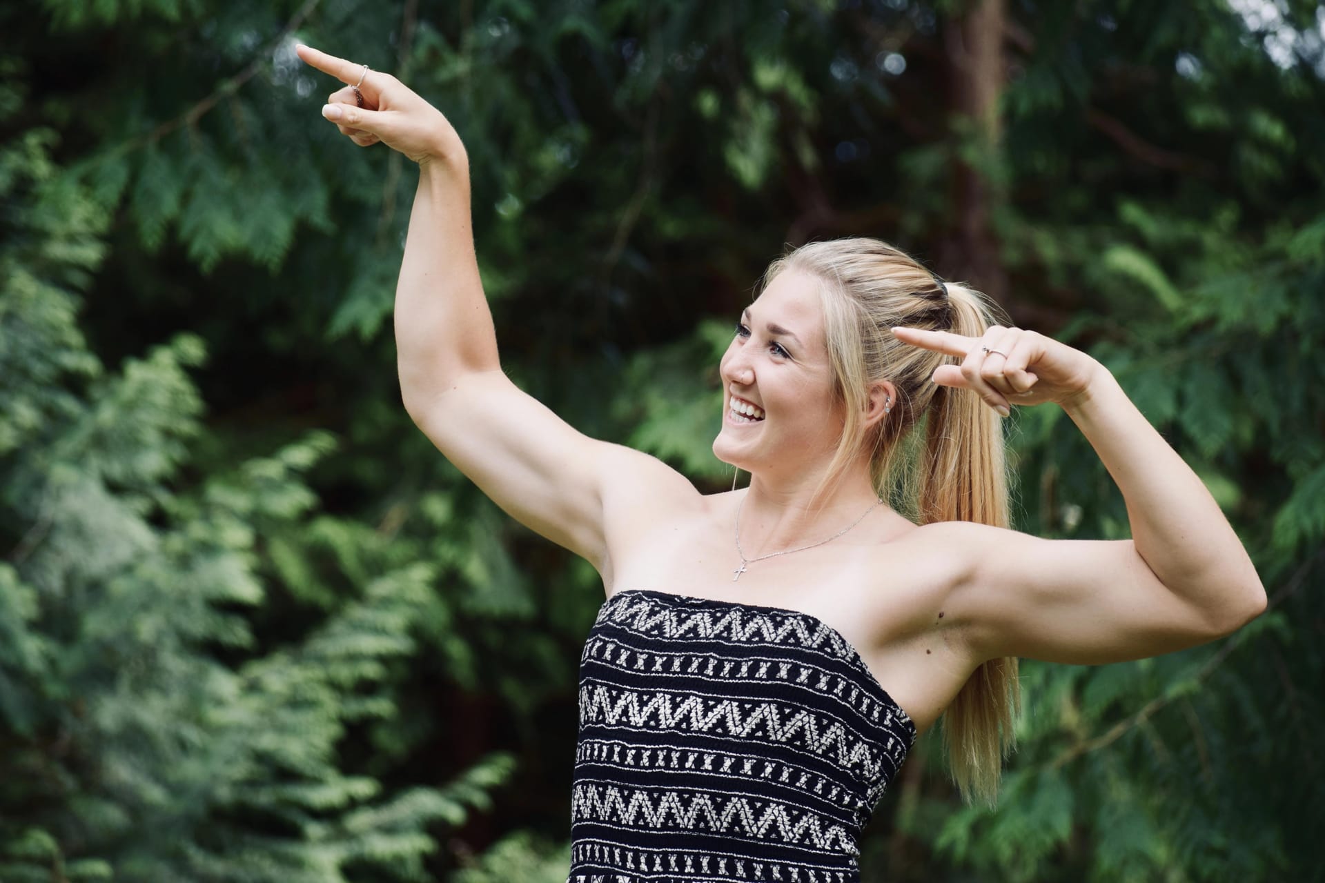 Mackenzie Stewart smiling and striking a pose pointing upwards