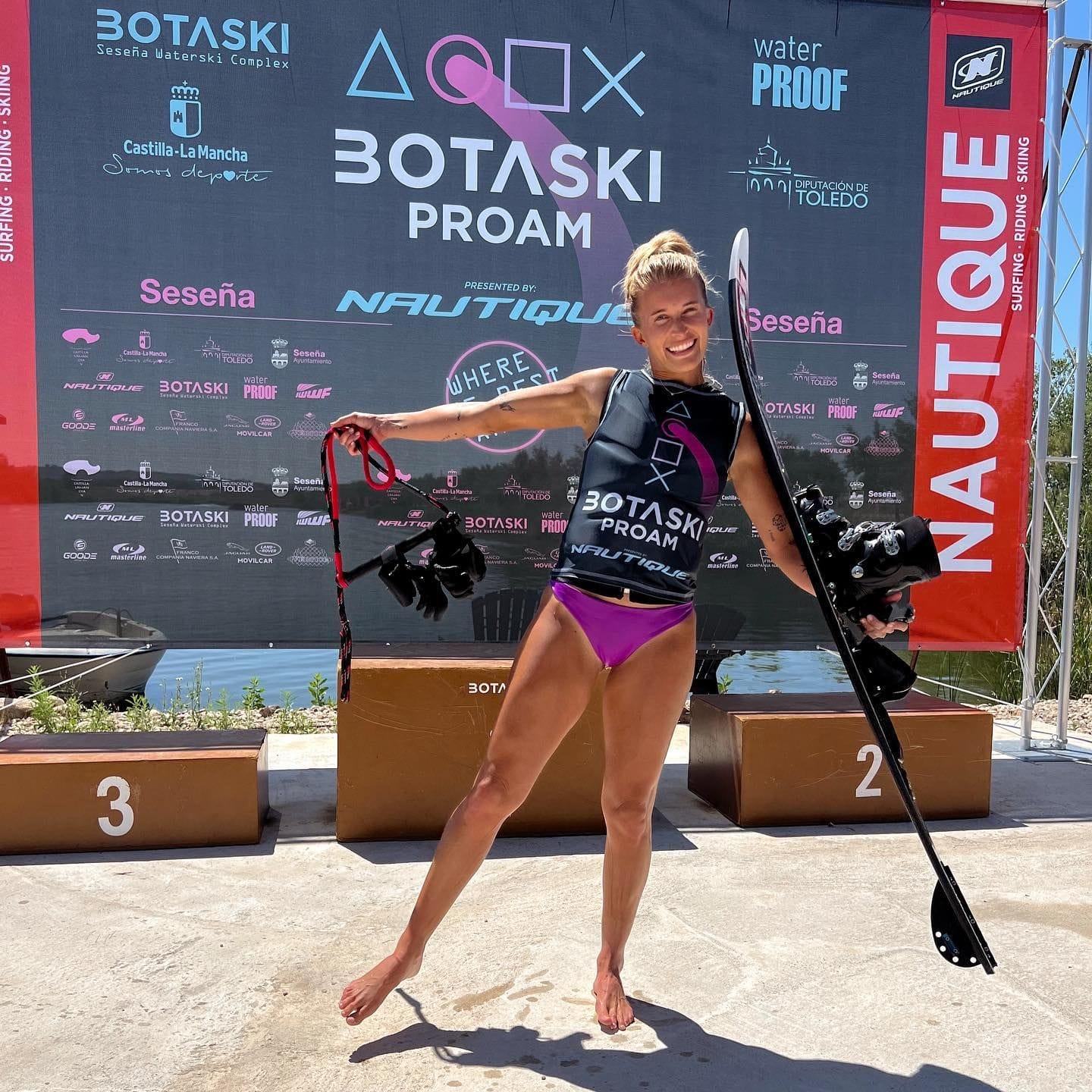 Elizabeth poses happily with her waterski at a competition