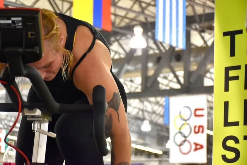Mallory trains on a stationary bike in an Olympic facility