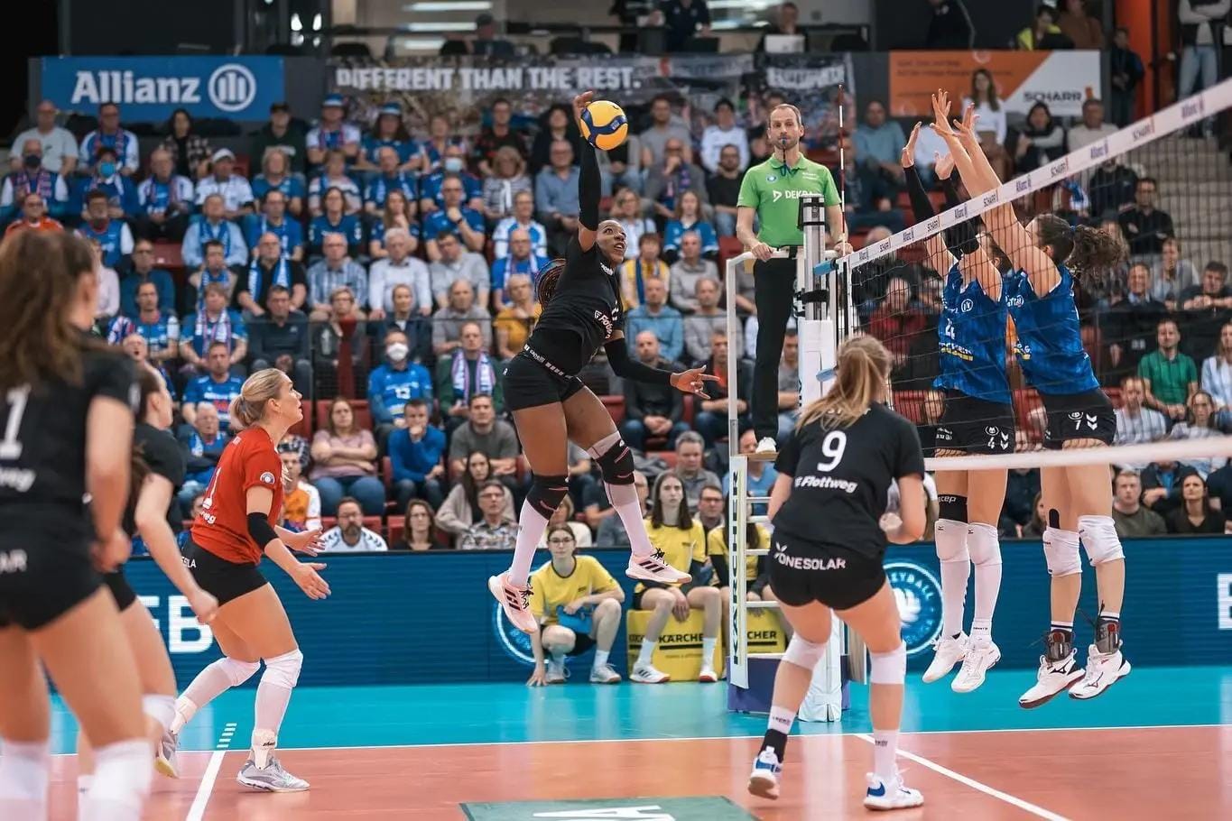 Channon leaping mid-air to spike the ball at a volleyball game