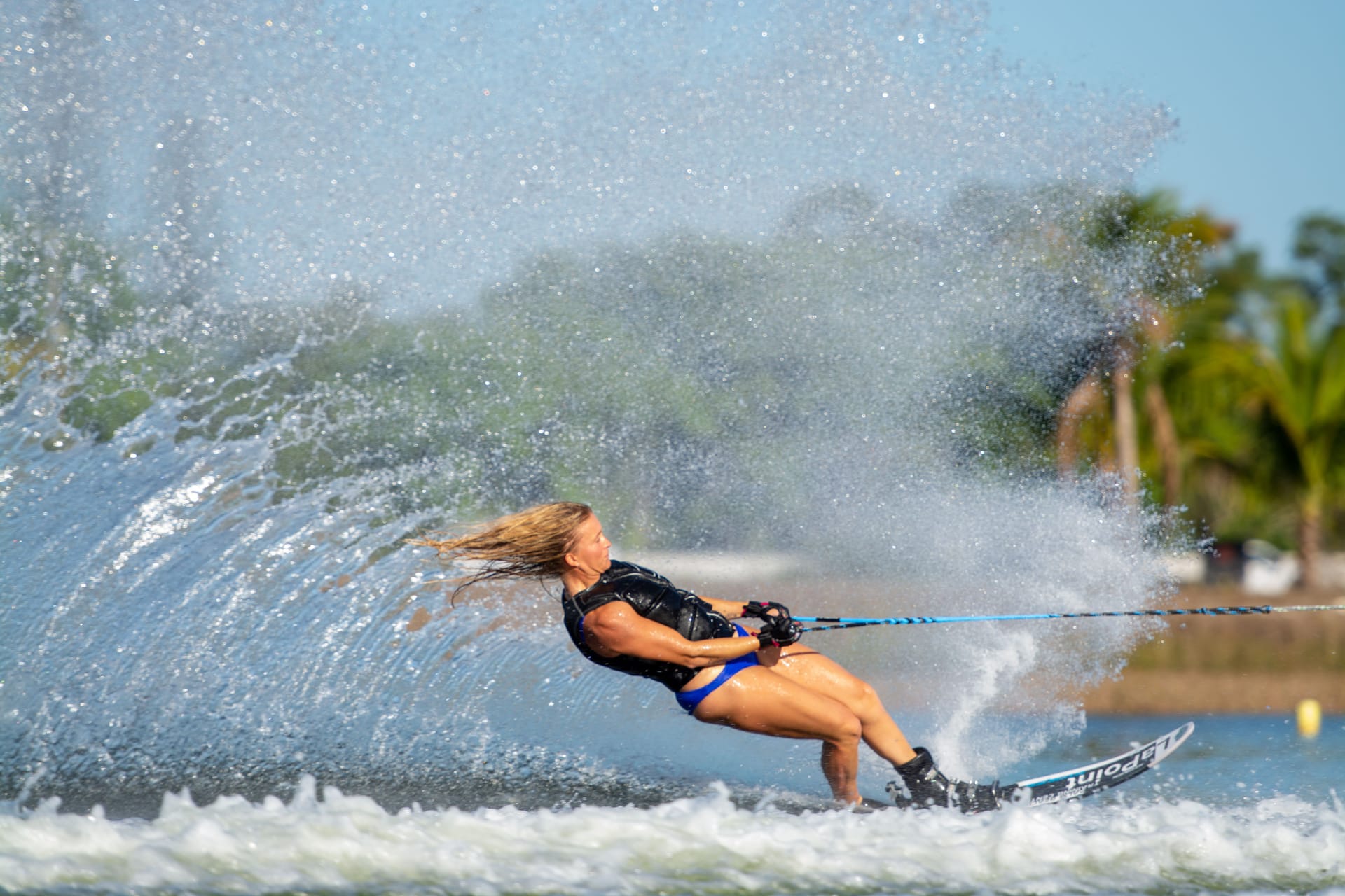Elizabeth waterskiing with a high curving wake behind her