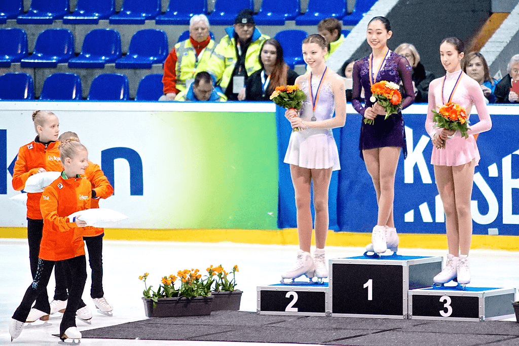 Emmy stands at the top of a podium to receive her first international gold medal. Won representing U.S. Figure Skating at the 2017 Challenge Cup in The Hague, Netherlands.