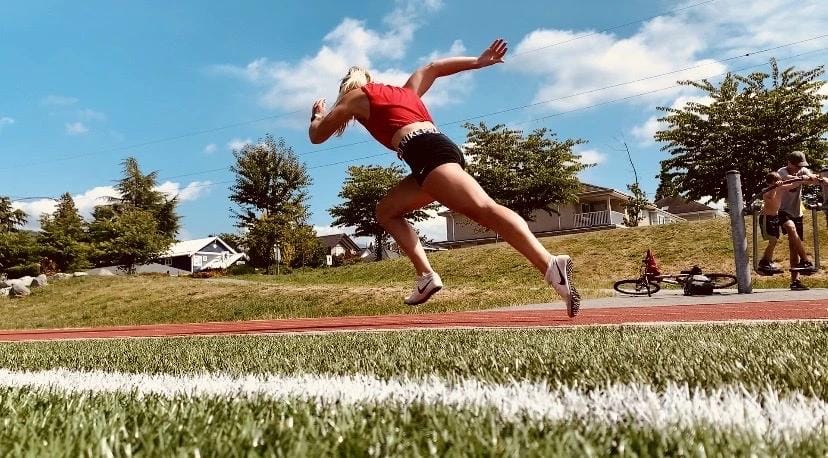 Mackenzie Stewart sprinting at an outdoor track